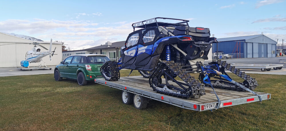 BYD e6 towing a tracked vehicle